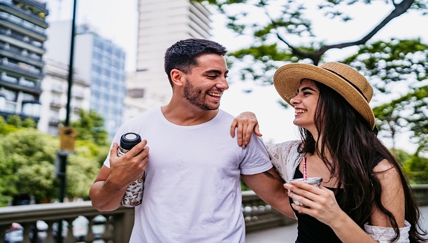 Two people laughing on a date in the park