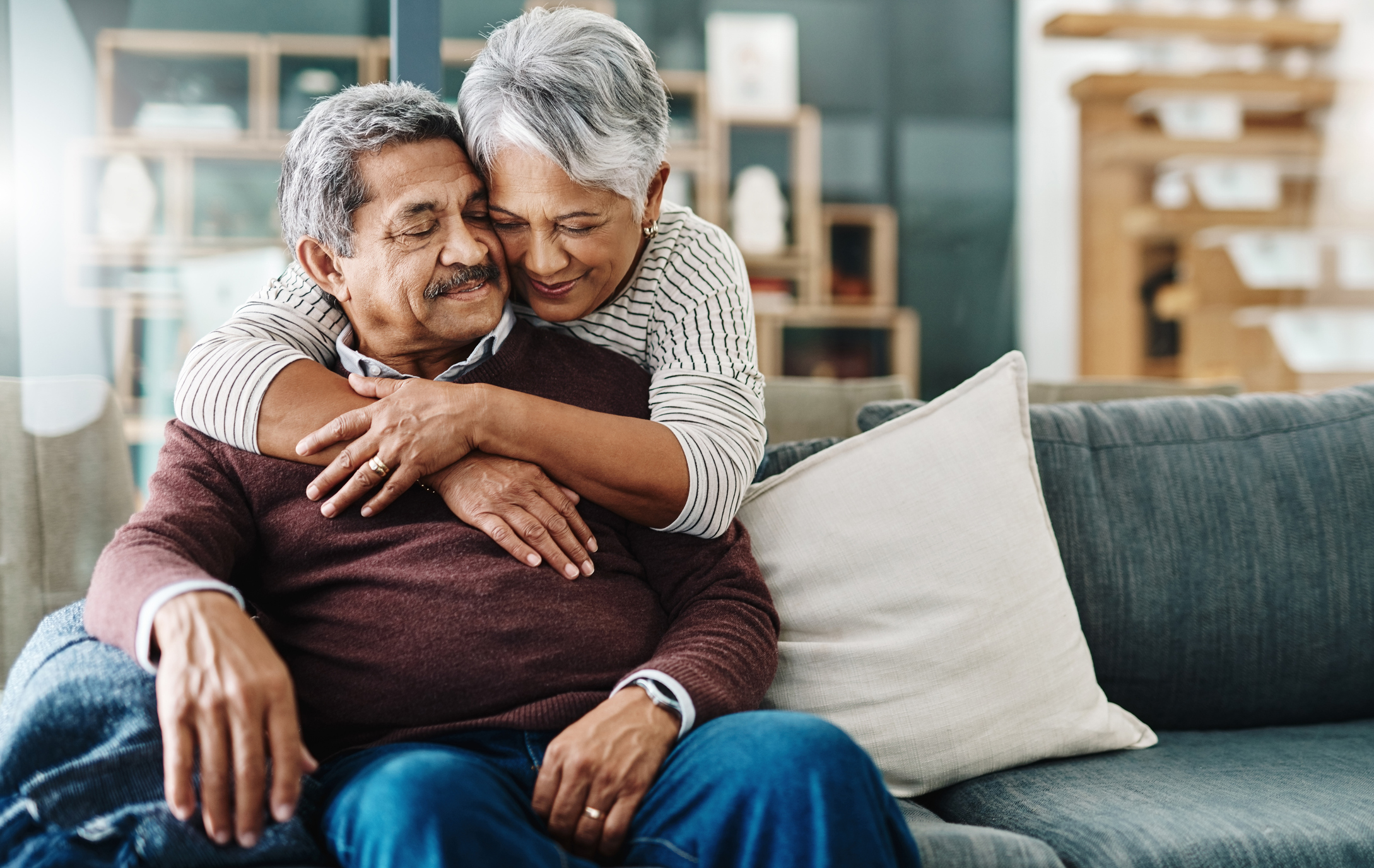 Elderly couple embracing after aphasia diagnosis