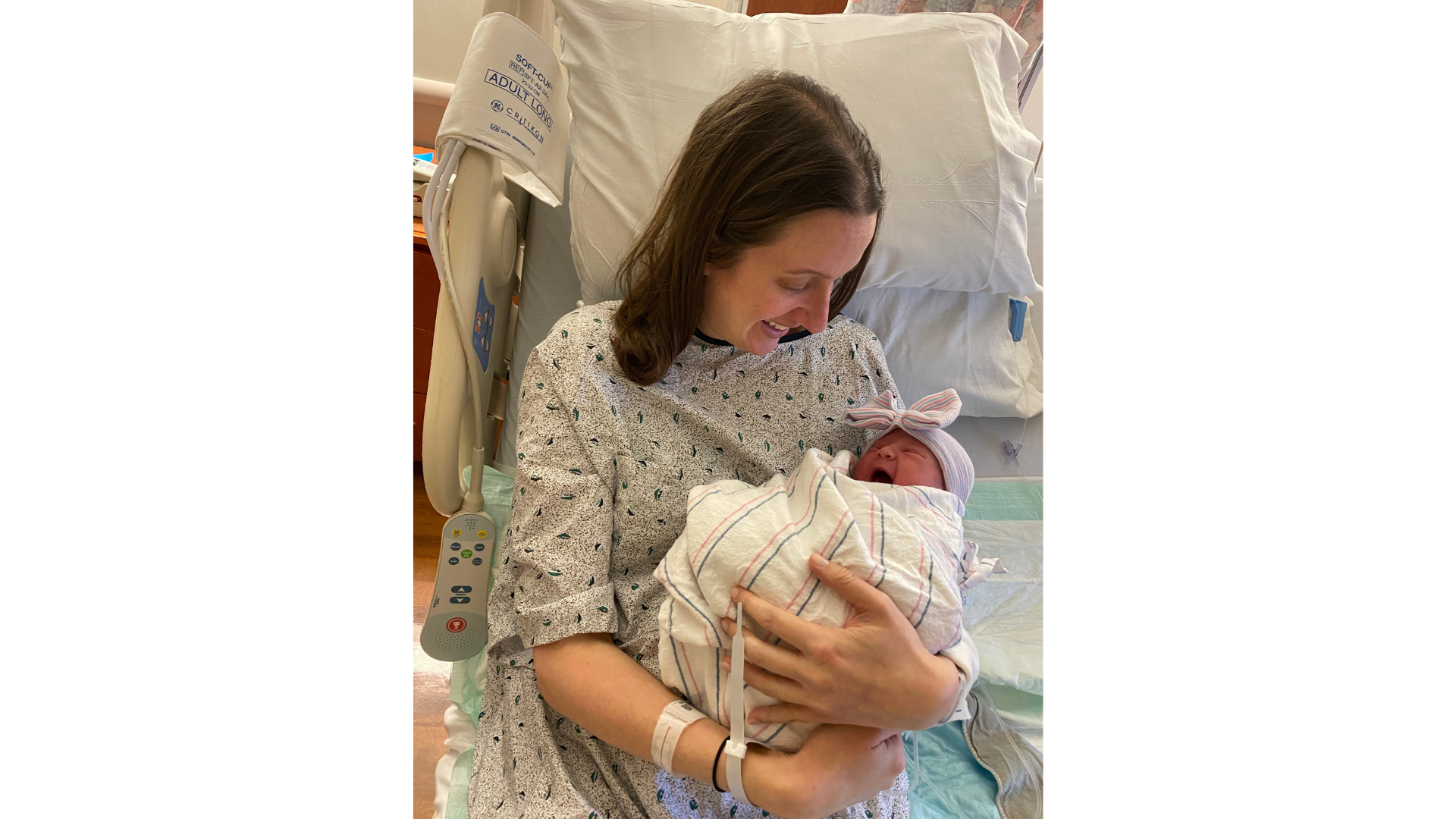 Carla Karp smiling while cradling her infant daughter after experiencing intrahepatic cholestasis of pregnancy (ICP)