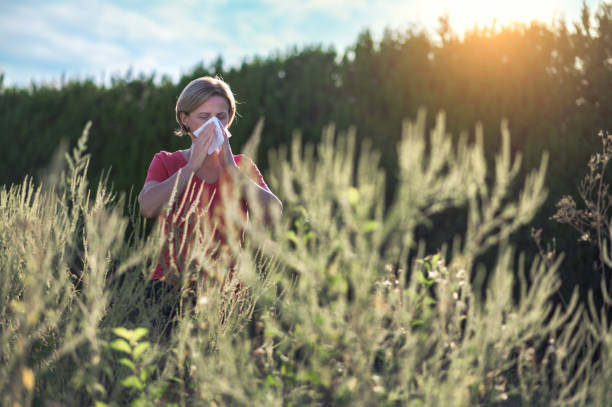 woman in a field experiencing fall allergies