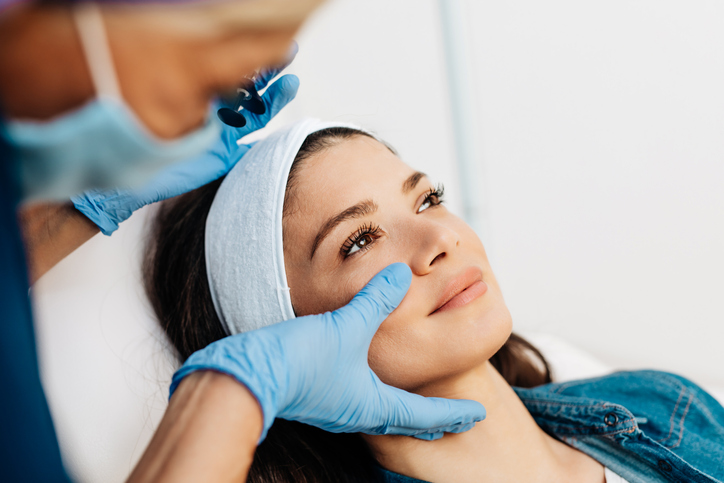 Attractive young woman is getting a rejuvenating facial injections